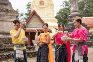 Young,Thai,People,Dress,In,Traditional,Thai,Costumes,And,Play