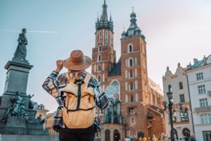 Back,View,Of,Traveller,Woman,Walking,On,Old,Market,Square